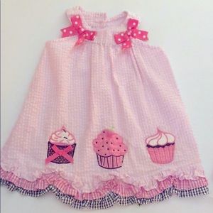 Pink “Rare, too!” Gingham dress with cupcakes.